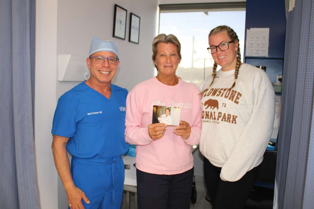Dr. Mark Denker with happy patients celebrating fertility treatment success